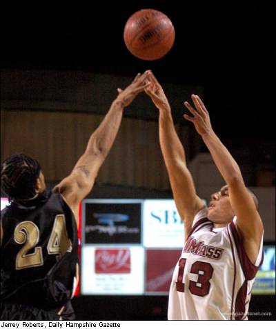 Max Groebe launches one of his seven 3-point attempts, this over AIC's Ryan Leak
