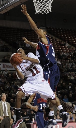 Gary Correia gets pinned under the hoop by Justin Harper