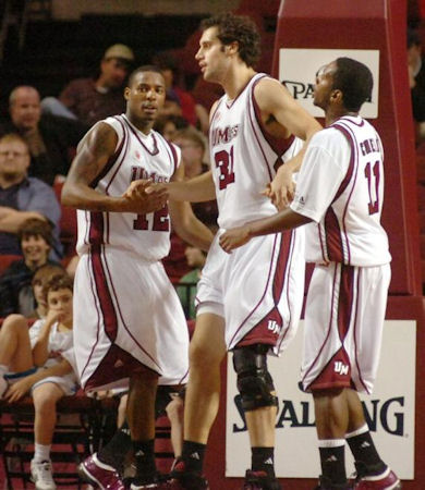 Luke Bonner gets an assist from Anthony Gurley (L) and Gary Correia (R)