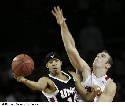 Tiki Mayben looks for options as David Padgett cuts off the lane